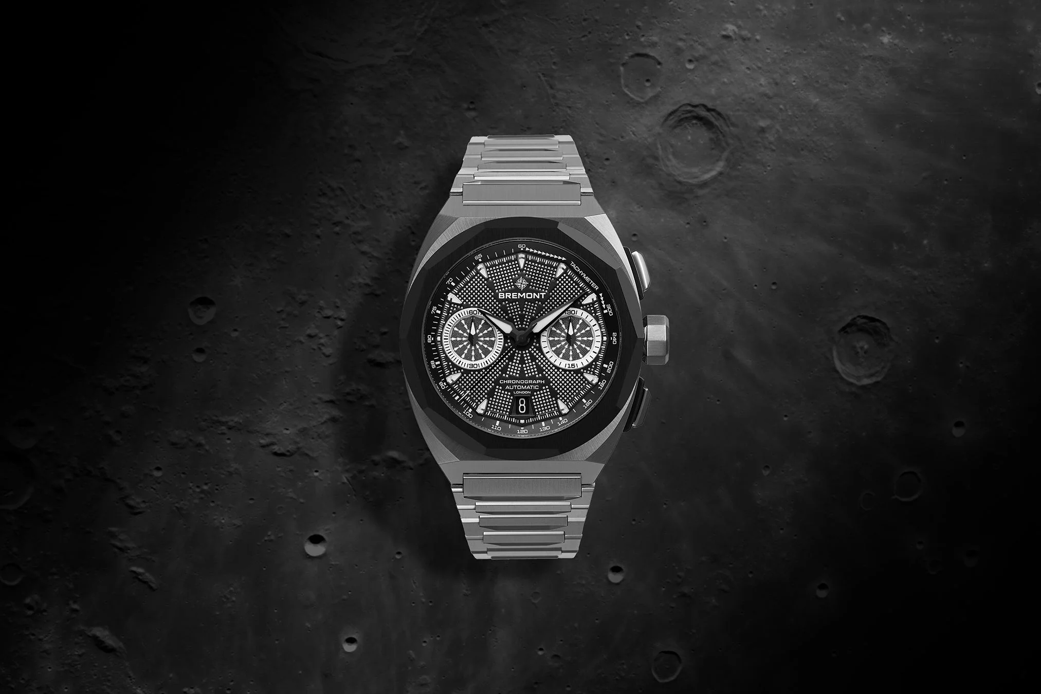 Bremont's Supernova Wristwatch displayed on a moon surface texture