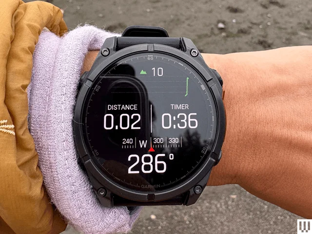 A wrist wearing a black Garmin Fenix 8 AMOLED a digital wristwatch for fitness tracking with the watchface screen...