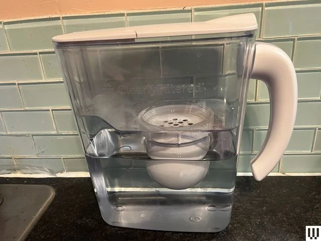 Image may contain: Device, Person, Appliance, and Electrical Device